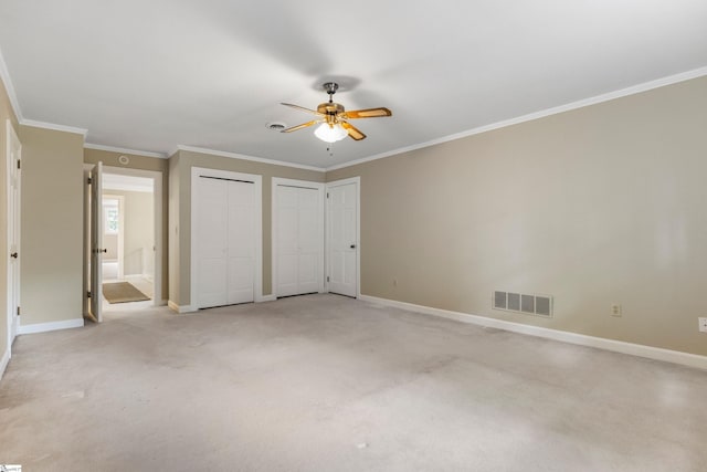 21 Kensington Rd, Greenville, SC 29617 - unfurnished bedroom with multiple closets, baseboards, light colored carpet, and crown molding
