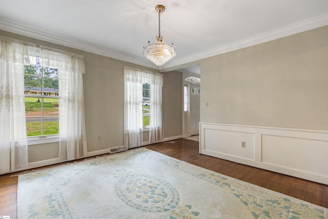 21 Kensington Rd, Greenville, SC 29617 - unfurnished room featuring wood finished floors, plenty of natural light, crown molding, a chandelier, and a wainscoted wall