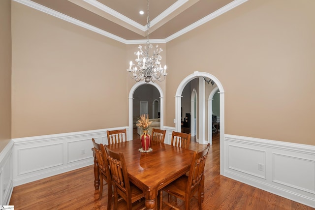 3 Swamp Lily Ct, Simpsonville, SC 29681 - dining room with arched walkways, a decorative wall, a chandelier, wood finished floors, and a wainscoted wall