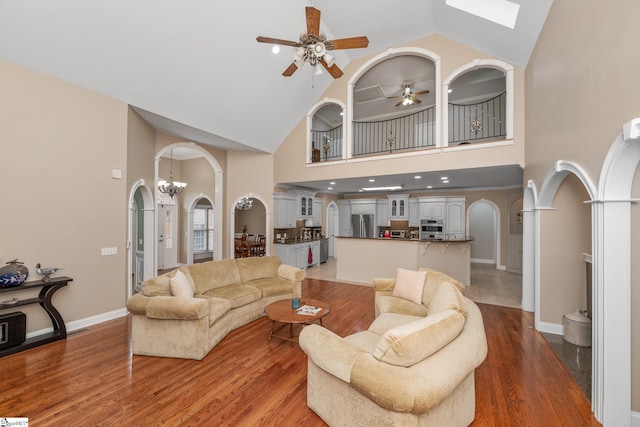 3 Swamp Lily Ct, Simpsonville, SC 29681 - living area with high vaulted ceiling, arched walkways, ceiling fan, light wood-type flooring, and baseboards