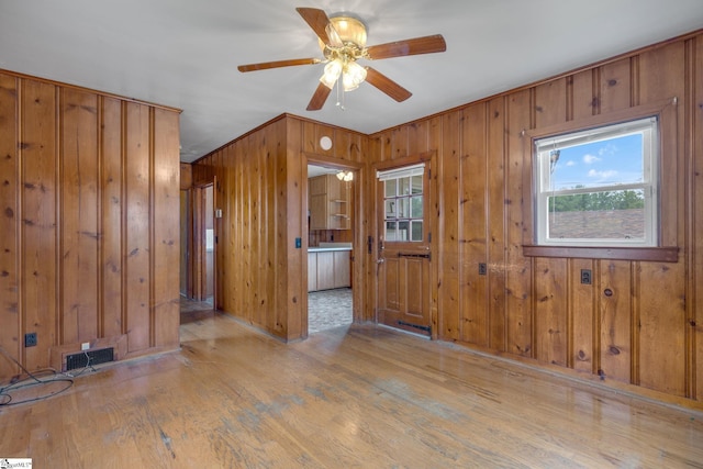 611 E S 6th St, Seneca, SC 29678 - spare room featuring healthy amount of natural light, wood walls, wood finished floors, and ceiling fan