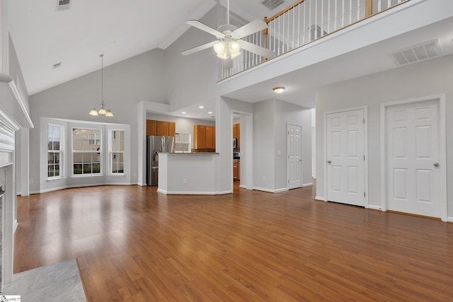 100 Beason Farm Ln, Simpsonville, SC 29681 - unfurnished living room featuring high vaulted ceiling, ceiling fan, wood finished floors, a chandelier, and baseboards