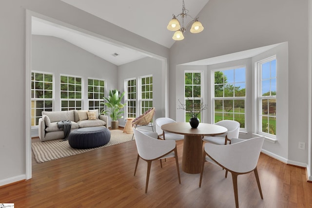 100 Beason Farm Ln, Simpsonville, SC 29681 - dining room with a chandelier, high vaulted ceiling, wood finished floors, and baseboards