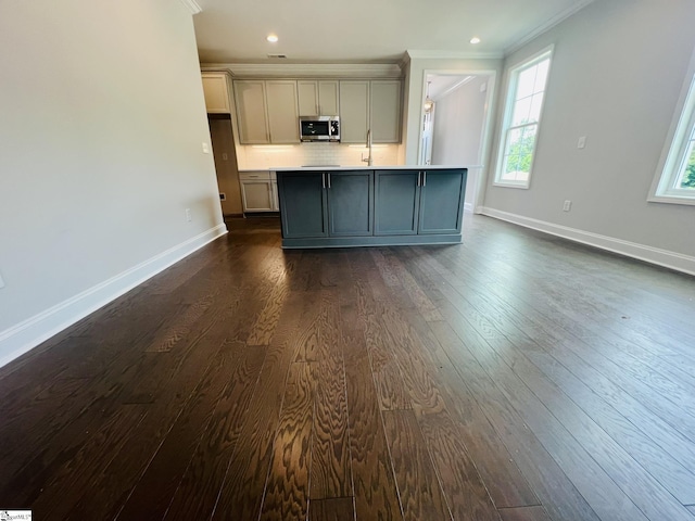 47 Hensley Rd Unit 58, Greenville, SC 29607 - kitchen with stainless steel microwave, gray cabinetry, ornamental molding, baseboards, and dark wood-style floors