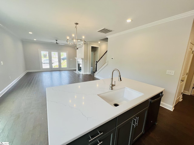 47 Hensley Rd Unit 58, Greenville, SC 29607 - kitchen featuring a sink, a chandelier, open floor plan, crown molding, and dark wood-style floors