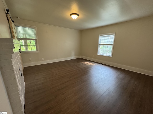 800 W Hampton St, Laurens, SC 29360 - unfurnished room featuring plenty of natural light, dark wood-style flooring, and baseboards