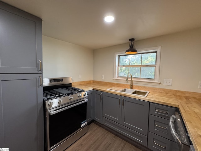 800 W Hampton St, Laurens, SC 29360 - kitchen with gas stove, butcher block counters, a sink, gray cabinets, and dark wood-style flooring