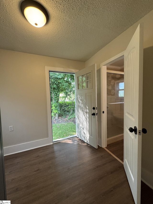 800 W Hampton St, Laurens, SC 29360 - entrance foyer featuring dark wood-style floors, plenty of natural light, baseboards, and a textured ceiling