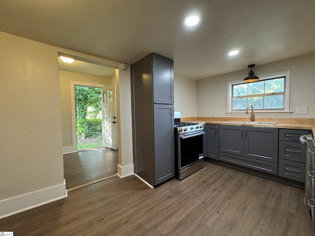 800 W Hampton St, Laurens, SC 29360 - kitchen with stainless steel range with gas stovetop, a sink, gray cabinets, dark wood finished floors, and baseboards