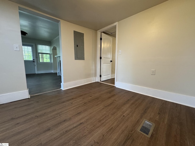 800 W Hampton St, Laurens, SC 29360 - unfurnished room with electric panel, dark wood-style flooring, baseboards, and arched walkways