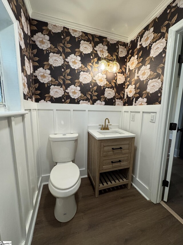 800 W Hampton St, Laurens, SC 29360 - half bathroom with wallpapered walls, ornamental molding, wood finished floors, a decorative wall, and toilet