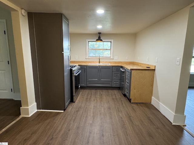 800 W Hampton St, Laurens, SC 29360 - kitchen with a sink, gas range, dark wood-type flooring, gray cabinetry, and baseboards