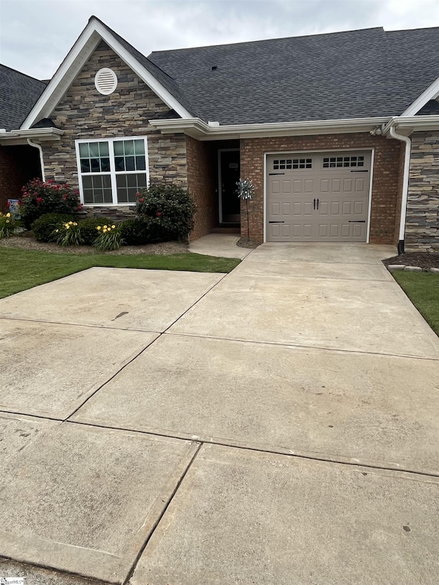 383 Amelia Springs Ln, Moore, SC 29369 - view of front facade featuring a garage, stone siding, a shingled roof, and driveway
