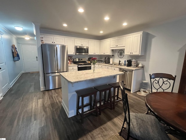 383 Amelia Springs Ln, Moore, SC 29369 - kitchen featuring stainless steel appliances, dark wood-type flooring, light countertops, a kitchen island, and ornamental molding