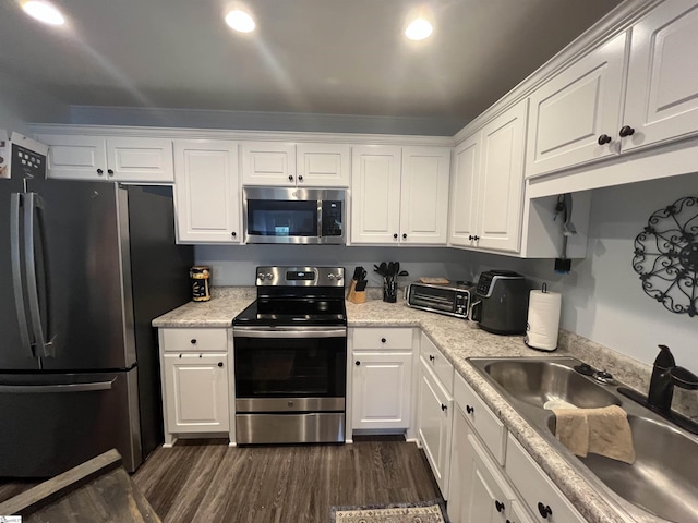 383 Amelia Springs Ln, Moore, SC 29369 - kitchen featuring appliances with stainless steel finishes, a sink, white cabinets, and dark wood-style floors