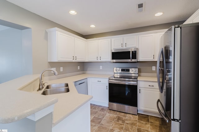 48 Border Ave, Simpsonville, SC 29680 - kitchen with appliances with stainless steel finishes, a sink, a peninsula, white cabinetry, and recessed lighting