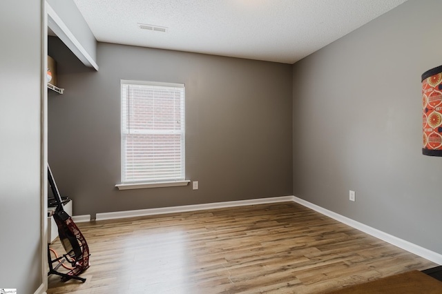 48 Border Ave, Simpsonville, SC 29680 - spare room featuring wood finished floors, baseboards, and a textured ceiling