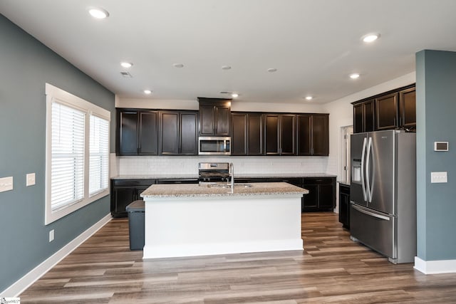 108 Pewter Cir, Simpsonville, SC 29680 - kitchen with appliances with stainless steel finishes, tasteful backsplash, baseboards, an island with sink, and recessed lighting