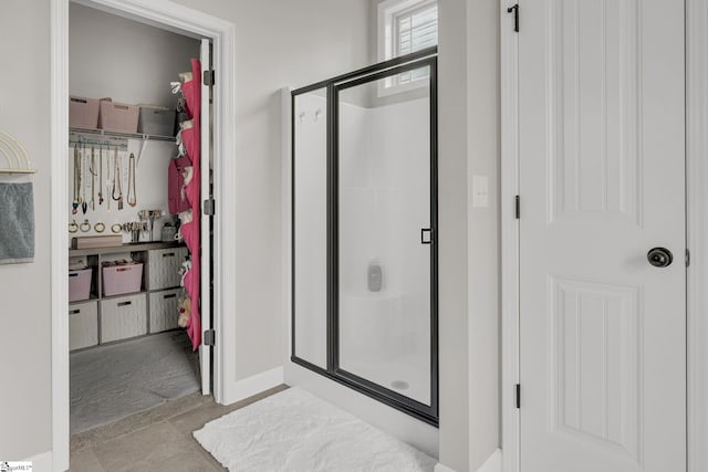 204 Medoc Ln, Moore, SC 26369 - bathroom with a stall shower, a walk in closet, and baseboards