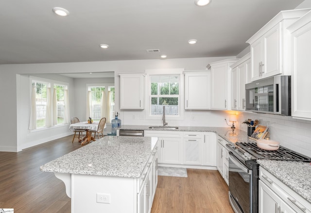 800 Redmill Ln, Duncan, SC 29334 - kitchen with stainless steel appliances, a sink, light wood finished floors, white cabinets, and recessed lighting