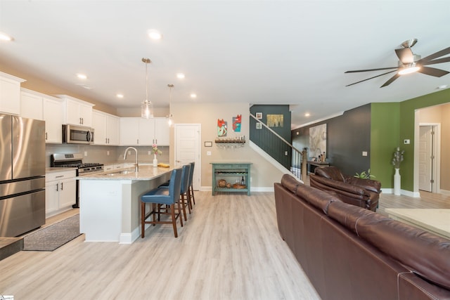 345 Cypress Hollow Trl, Piedmont, SC 29673 - kitchen featuring appliances with stainless steel finishes, a sink, open floor plan, white cabinets, and recessed lighting