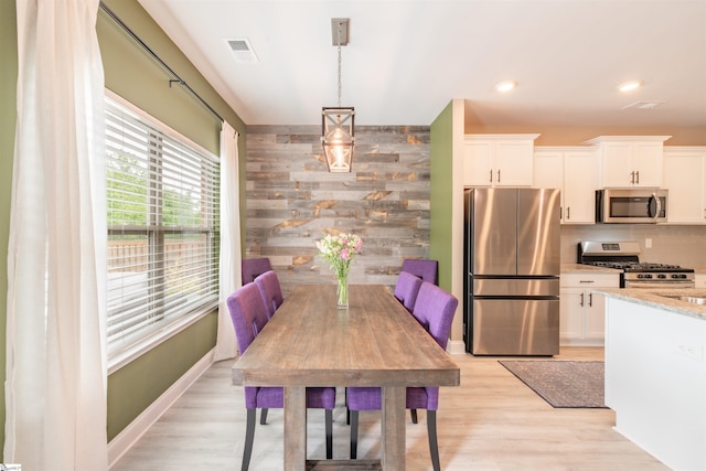 345 Cypress Hollow Trl, Piedmont, SC 29673 - dining room featuring light wood finished floors, wood walls, and recessed lighting