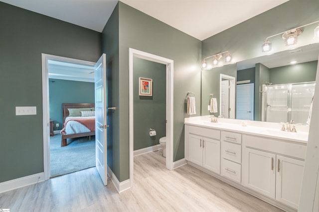345 Cypress Hollow Trl, Piedmont, SC 29673 - ensuite bathroom featuring toilet, wood finished floors, double vanity, a stall shower, and baseboards