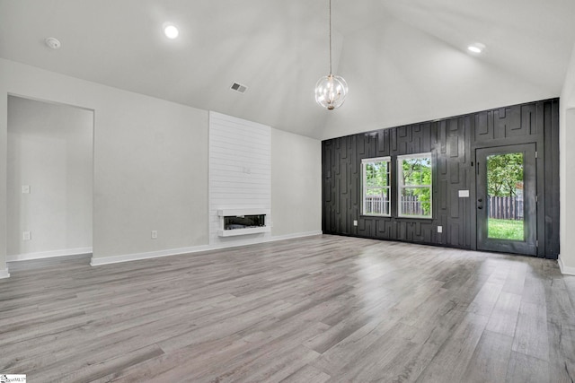 1708 Old Georgia Hwy, Gaffney, SC 29341 - unfurnished living room with high vaulted ceiling, a chandelier, a large fireplace, baseboards, and wood finished floors