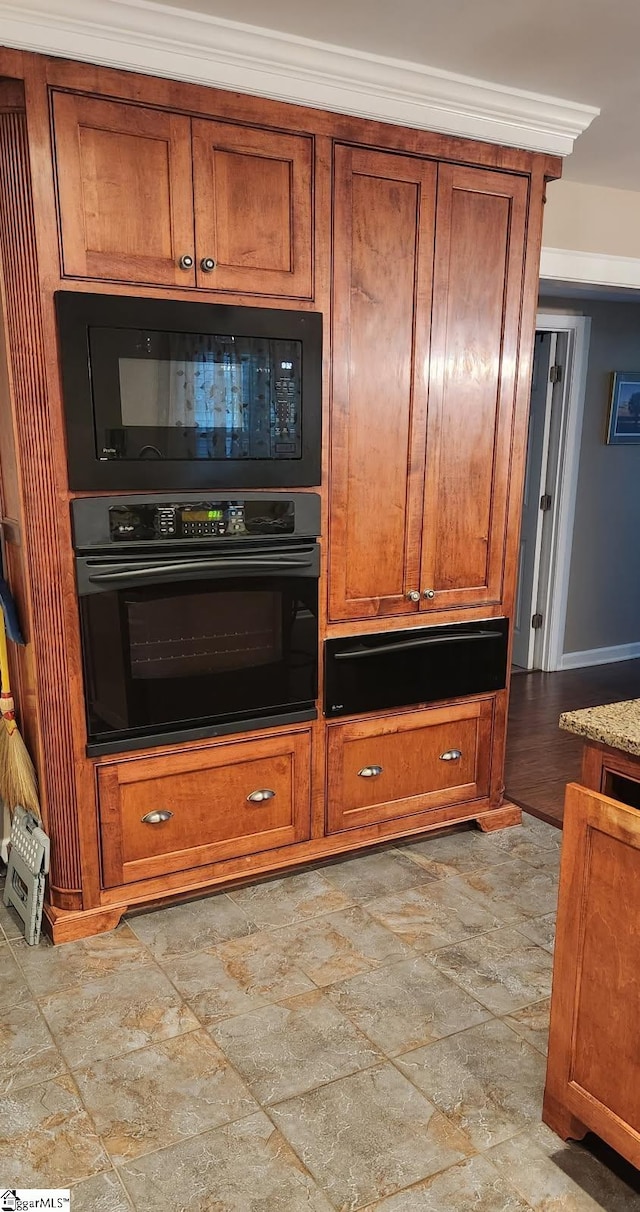 9 Lee St, Liberty, SC 29657 - kitchen featuring black appliances, light stone finish flooring, and brown cabinets