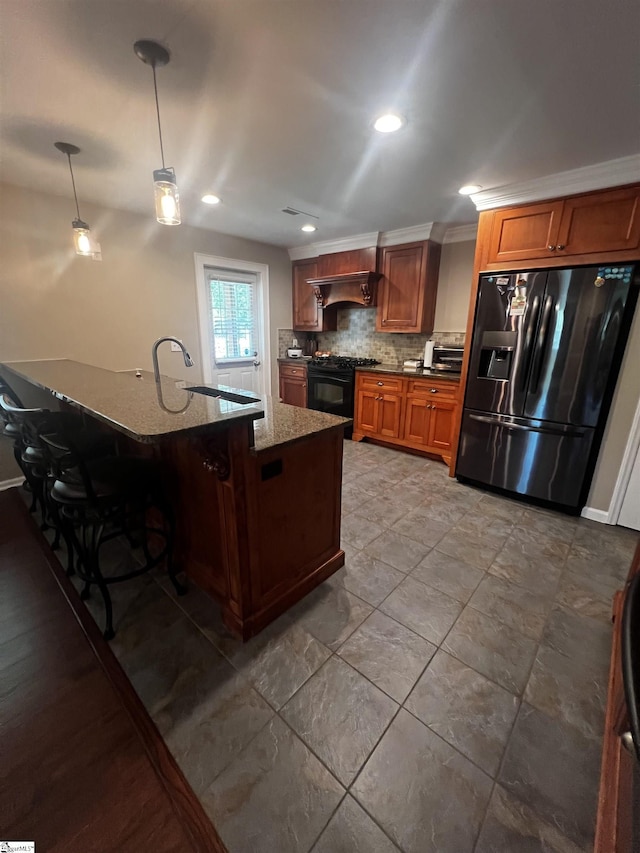 9 Lee St, Liberty, SC 29657 - kitchen with black appliances, tasteful backsplash, dark stone countertops, hanging light fixtures, and brown cabinetry