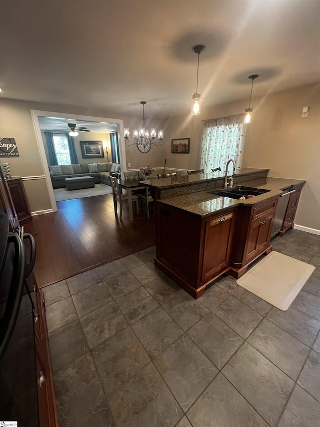 9 Lee St, Liberty, SC 29657 - kitchen featuring a sink, open floor plan, hanging light fixtures, dark stone countertops, and ceiling fan