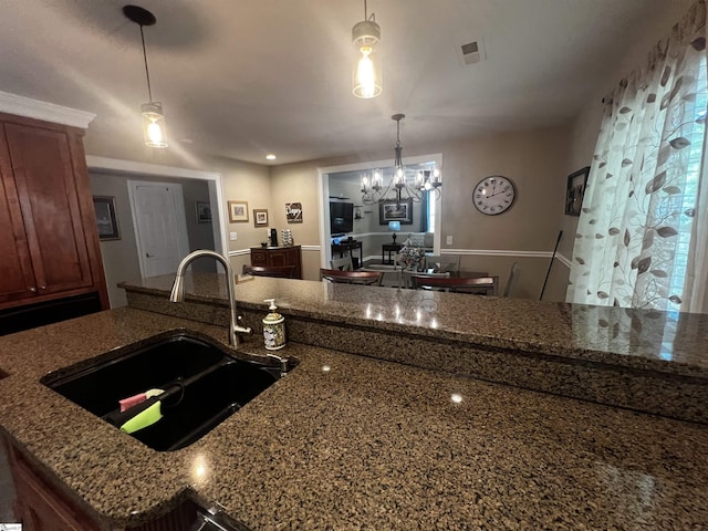 9 Lee St, Liberty, SC 29657 - kitchen featuring a sink, dark stone countertops, a chandelier, and hanging light fixtures