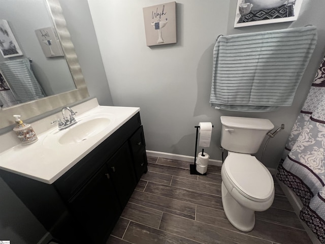 9 Lee St, Liberty, SC 29657 - bathroom featuring vanity, toilet, wood tiled floors, and baseboards