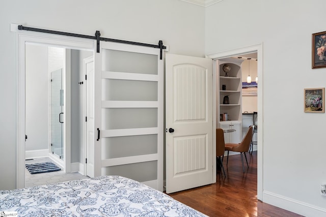 416 Shirley Cir, Pendleton, SC 29625 - bedroom featuring baseboards, a barn door, wood finished floors, and ensuite bath