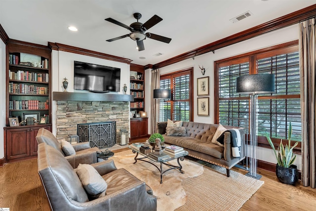 172 Ridgeland Dr # 101, Greenville, SC 29601 - living room with ceiling fan, ornamental molding, wood finished floors, a stone fireplace, and baseboards