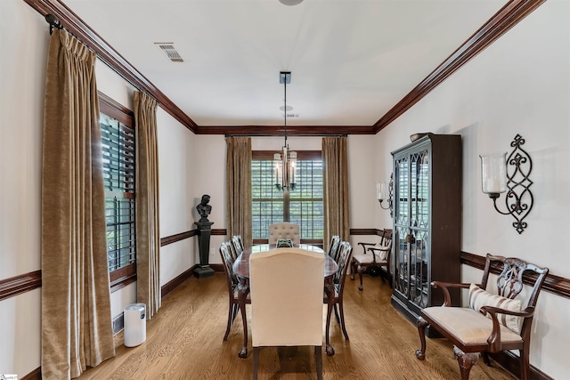172 Ridgeland Dr # 101, Greenville, SC 29601 - dining space with a chandelier, wood finished floors, crown molding, and baseboards
