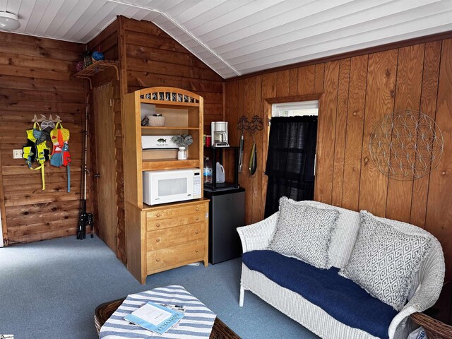 1700 W Lakeshore Dr Lot K, Landrum, SC 29356 - carpeted living area featuring vaulted ceiling and wood walls