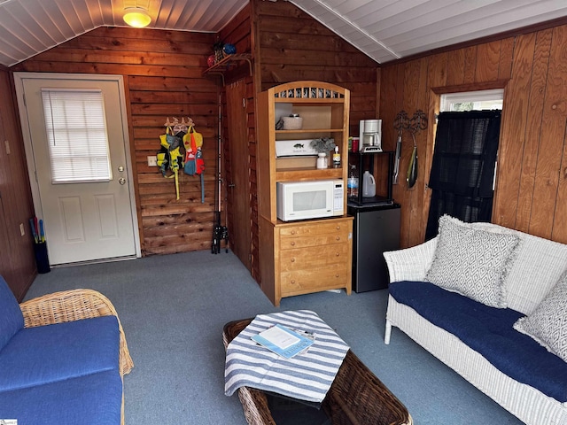 1700 W Lakeshore Dr Lot K, Landrum, SC 29356 - carpeted living room featuring vaulted ceiling and wood walls