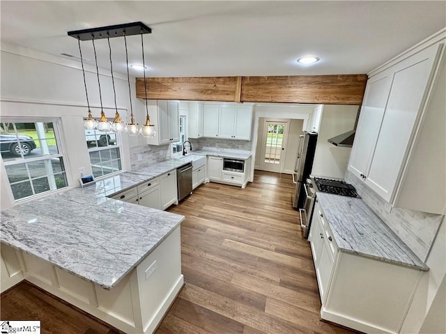 800 Holiday Dam Rd, Honea Path, SC 29654 - kitchen with appliances with stainless steel finishes, a peninsula, tasteful backsplash, light stone counters, and recessed lighting