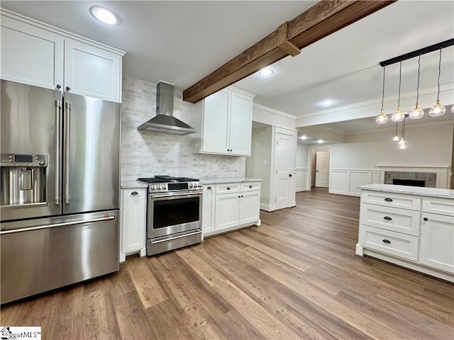 800 Holiday Dam Rd, Honea Path, SC 29654 - kitchen with stainless steel appliances, wall chimney exhaust hood, light countertops, decorative backsplash, and light wood-type flooring