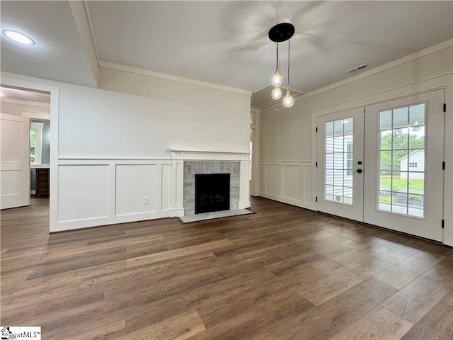 800 Holiday Dam Rd, Honea Path, SC 29654 - unfurnished living room featuring a decorative wall, ornamental molding, french doors, wood finished floors, and a fireplace with flush hearth