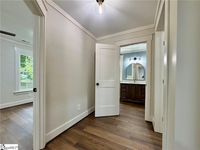 800 Holiday Dam Rd, Honea Path, SC 29654 - corridor featuring dark wood-type flooring, baseboards, crown molding, and a sink