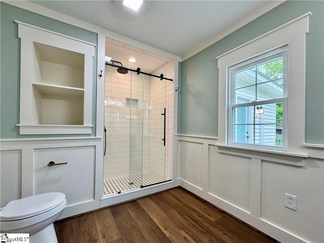 800 Holiday Dam Rd, Honea Path, SC 29654 - full bath featuring a shower stall, toilet, wainscoting, a decorative wall, and wood finished floors