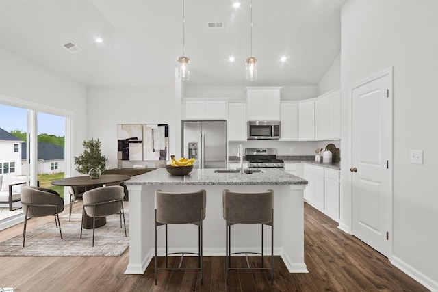 1142 Berry Patch Dr, Lyman, SC 29365 - kitchen with stainless steel appliances, a sink, a center island with sink, light stone countertops, and dark wood-style flooring
