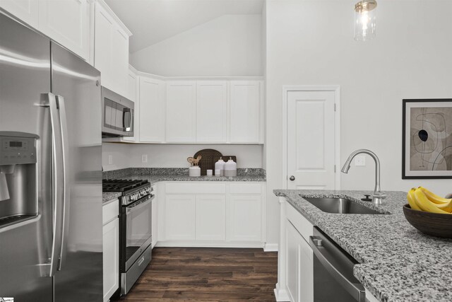 1142 Berry Patch Dr, Lyman, SC 29365 - kitchen with appliances with stainless steel finishes, a sink, white cabinetry, light stone counters, and vaulted ceiling