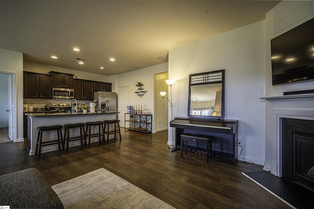 350 Hartleigh Dr, Lyman, SC 29365 - kitchen featuring appliances with stainless steel finishes, a kitchen breakfast bar, dark wood-style floors, recessed lighting, and dark countertops
