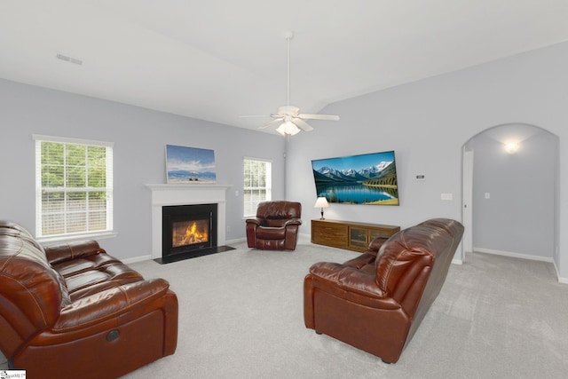 160 Spirit Mountain Ln, Easley, SC 29642 - carpeted living room with arched walkways, a fireplace with flush hearth, a ceiling fan, and baseboards