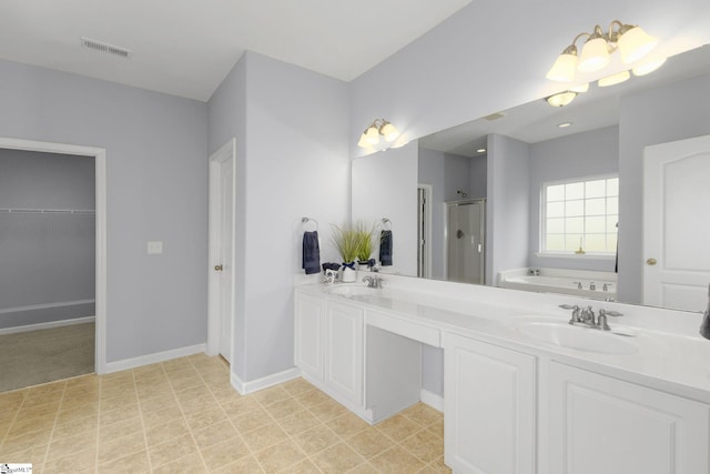 160 Spirit Mountain Ln, Easley, SC 29642 - bathroom with a shower stall, a bath, baseboards, double vanity, and a spacious closet