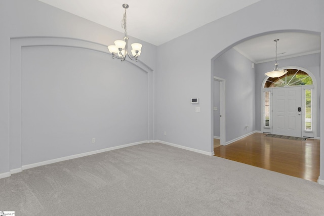 160 Spirit Mountain Ln, Easley, SC 29642 - carpeted empty room featuring arched walkways, a chandelier, baseboards, and crown molding