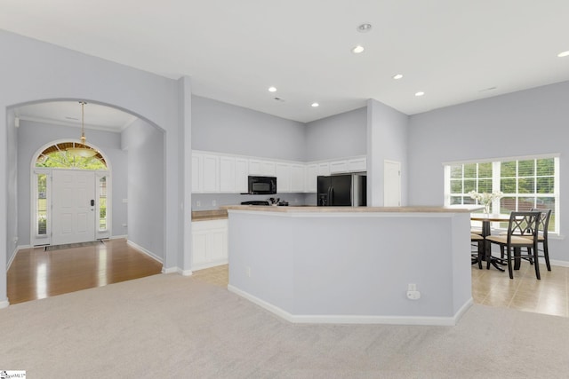 160 Spirit Mountain Ln, Easley, SC 29642 - kitchen featuring black appliances, light colored carpet, arched walkways, recessed lighting, and baseboards